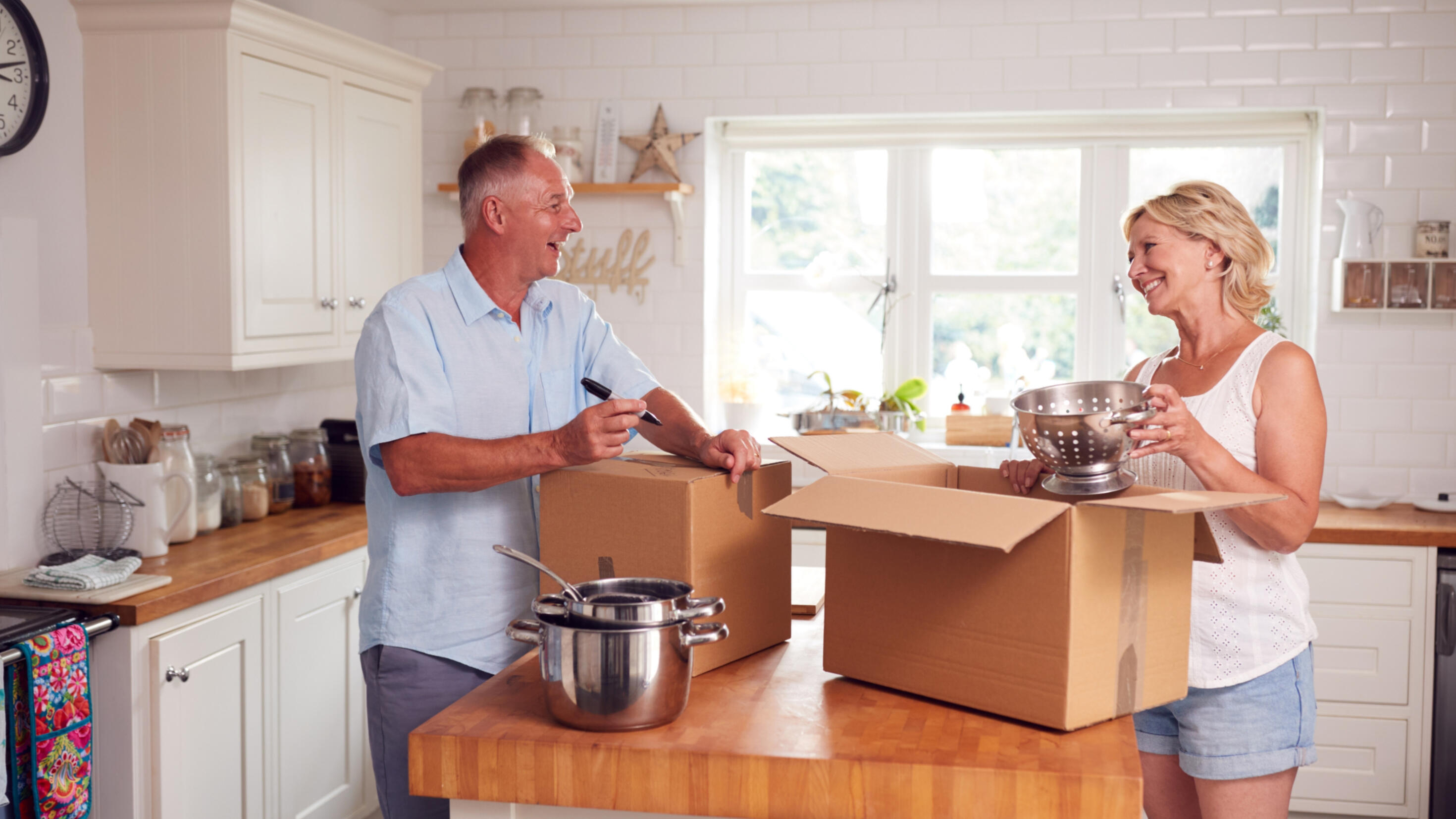 Image of Happy Seniors 55+ packing for moving, property managed by Gabriela Jonas for Sellers